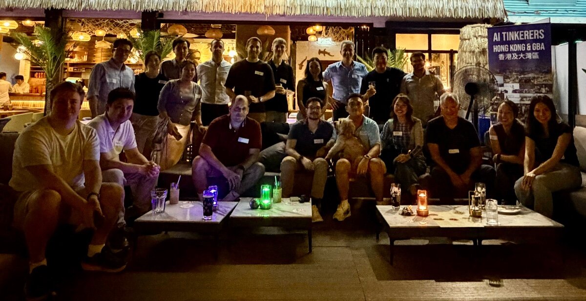 A group photo of attendees posing together at an AI Tinkerers event in Hong Kong & GBA, set in an outdoor lounge at night.. Text: AI TINKERERS
HONG KONG & GBA
香港及大灣區