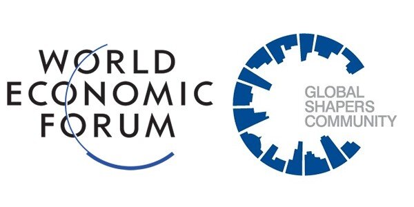 (Logo) The image displays two corporate logos side-by-side on a white background: the World Economic Forum logo and the Global Shapers Community logo. Text: WORLD ECONOMIC FORUM GLOBAL SHAPERS COMMUNITY Colors: #000000, #FFFFFF, #0056B3, #808080 Note: The image consists of two distinct, professionally designed graphic marks used for organizational identification and branding, which defines them as logos.