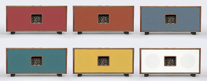 The image displays six variations of a rectangular electronic device, likely a stereo receiver or amplifier, each with a different colored front panel and a visible pair of vacuum tubes.