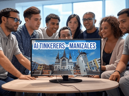 A group of people are gathered around a computer monitor, looking at an image of a city with the text "AI Tinkerers - Manizales" displayed above it.