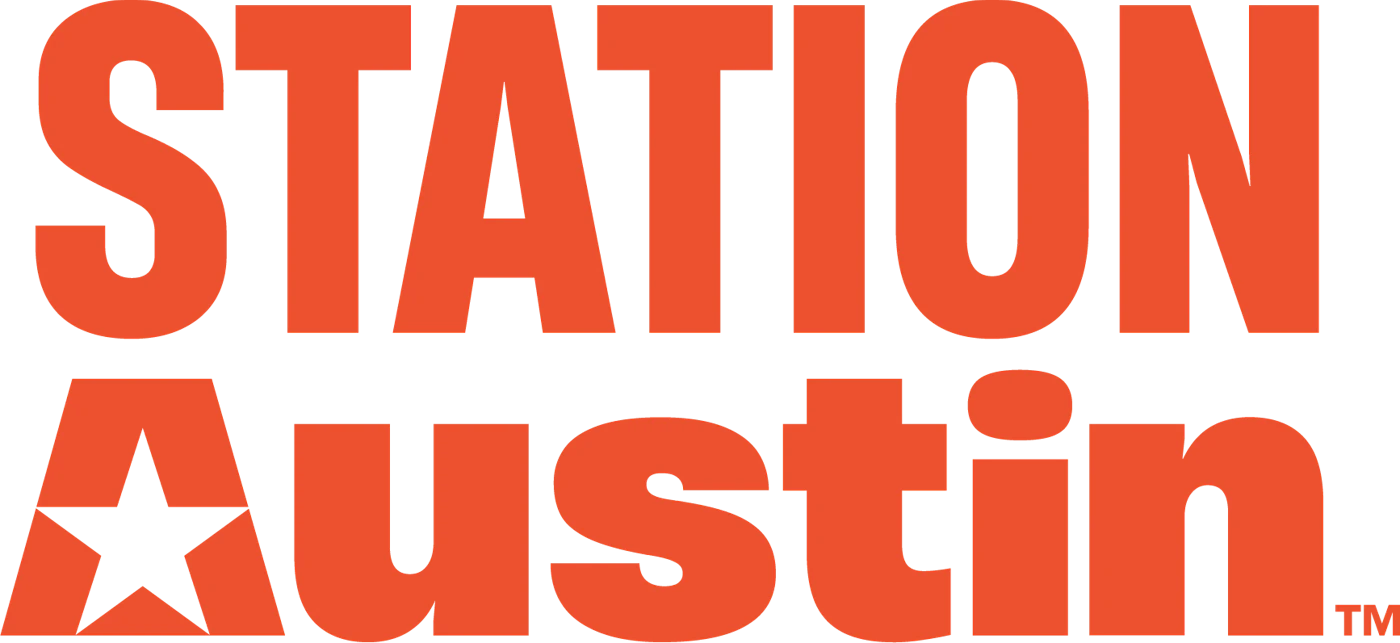 (Logo) A logo for 'STATION Austin' featuring bold orange typography on a black background, with a star integrated into the letter 'A'. Text: STATION Austin TM Colors: #F15A29, #000000 Note: The image is a stylized typographic mark representing a brand name, which is the primary function of a logo.